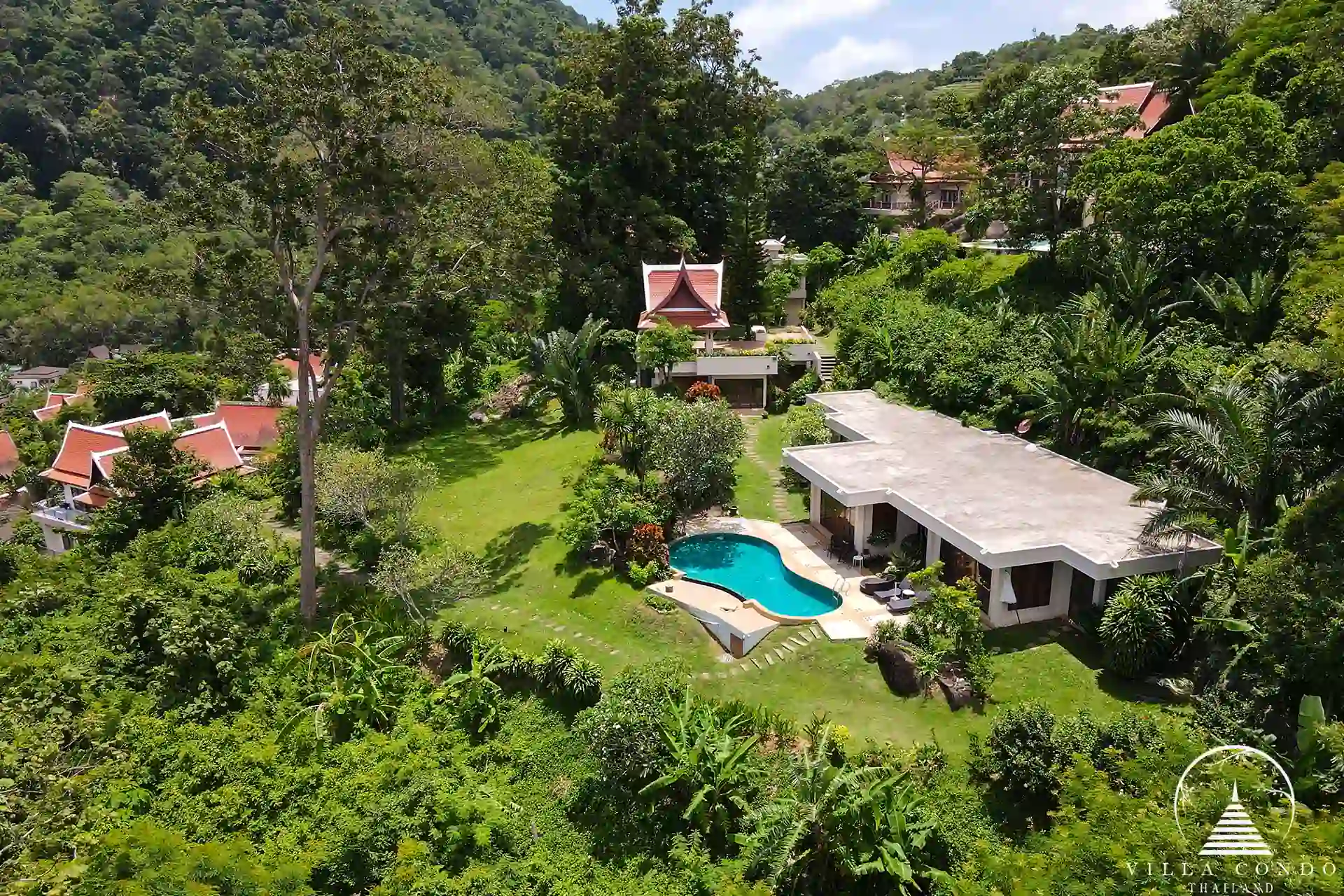 Bird's-eye view of Nakathani Villa Estate Kamala Beach with surrounding greenery and ocean views.