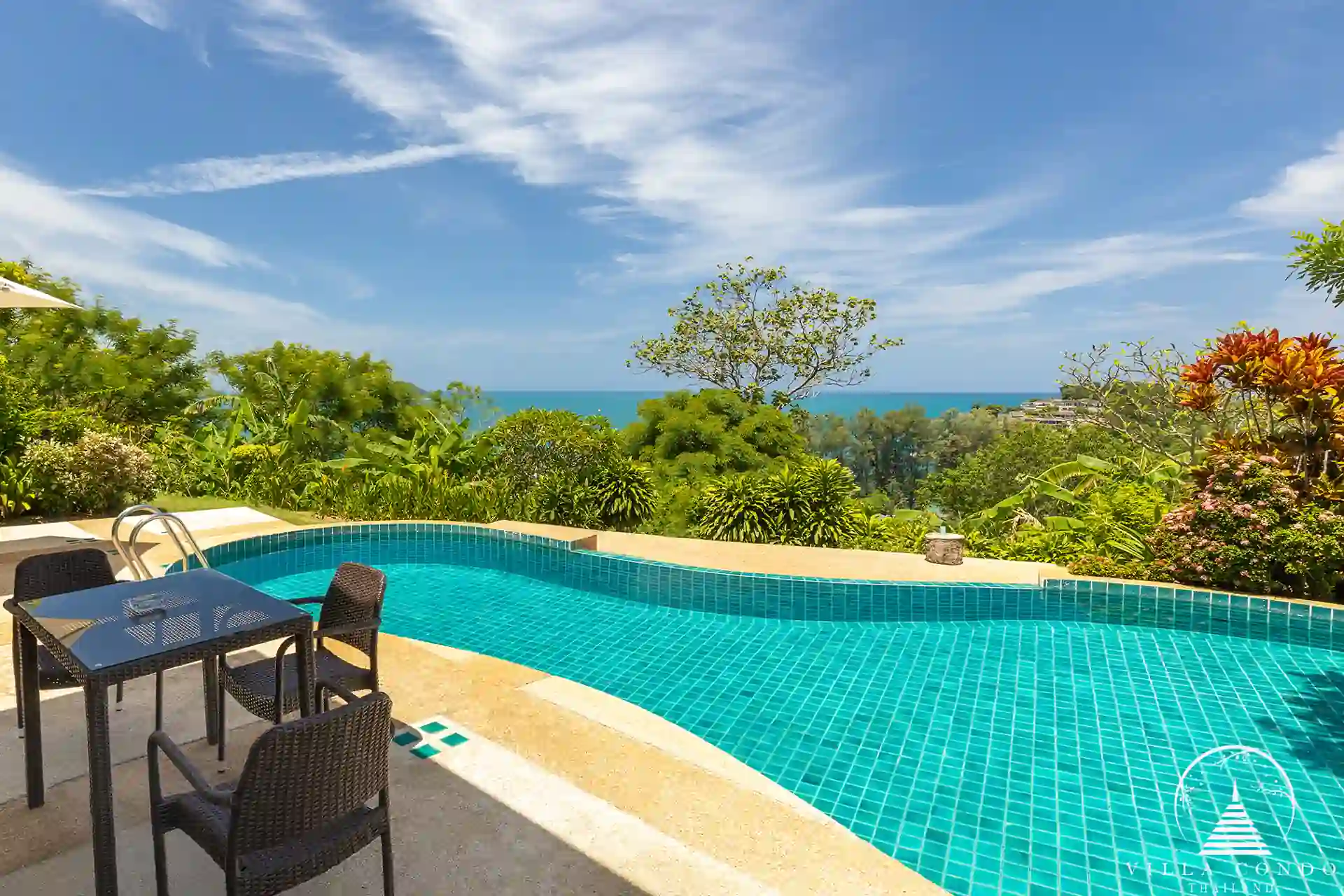 Private swimming pool at Nakathani Villa Estate Kamala Beach surrounded by lush tropical plants.