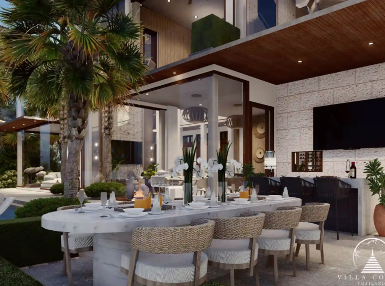Outdoor dining area at Narana Villa Phuket, featuring a modern table with lush garden views.