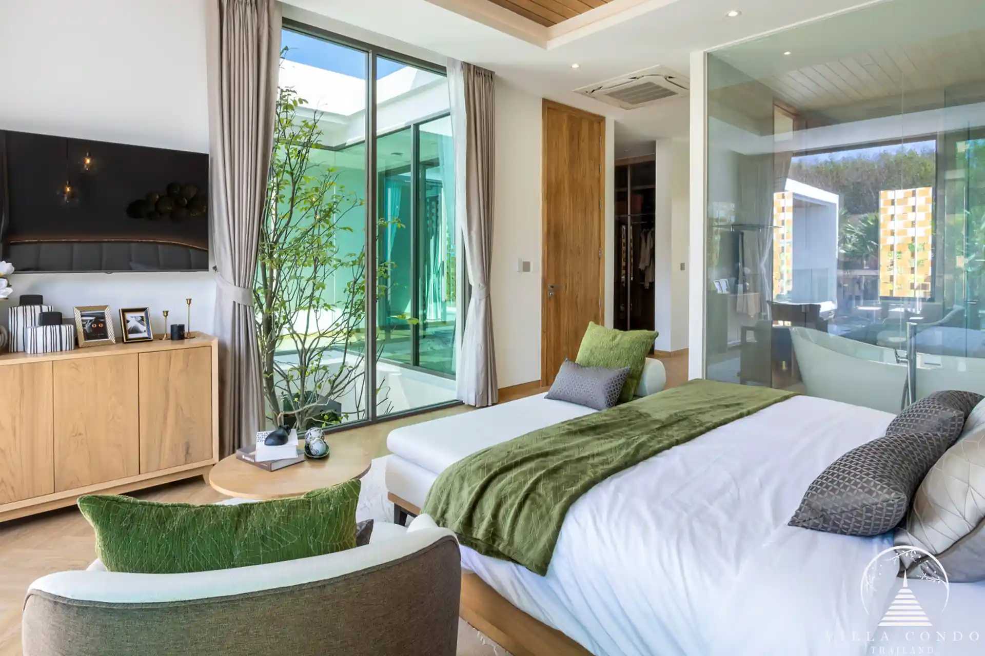 Cozy bedroom in The Teak Phuket with modern furnishings and natural lighting