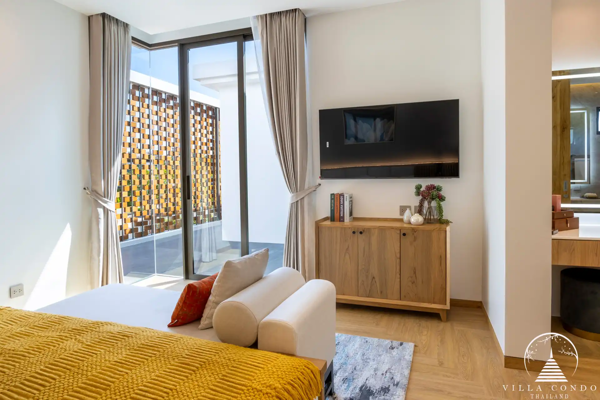 Cozy bedroom in The Teak Phuket with modern furnishings and natural lighting