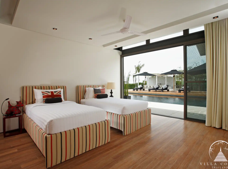 Spacious bedroom in Villa Essenza Natai Beach Front with sea views and stylish décor.