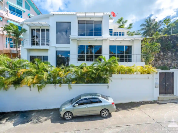 White Villa Patong exterior view with modern architecture and sea views.