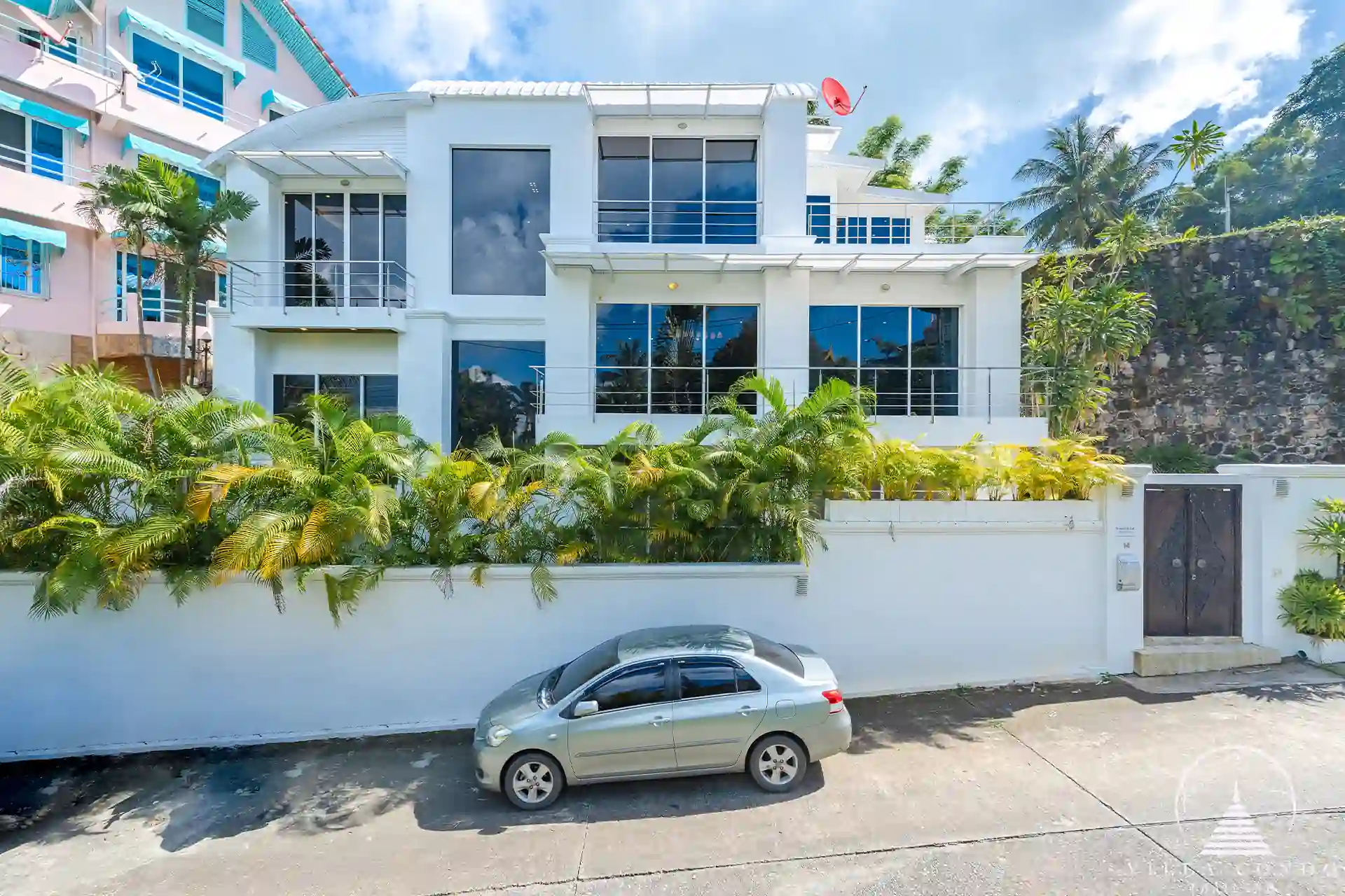 White Villa Patong exterior view with modern architecture and sea views.