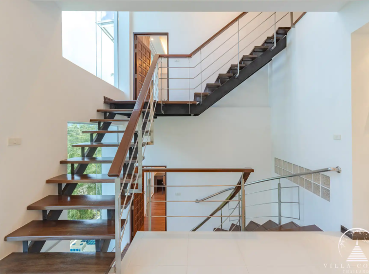 White Villa Patong modern staircase connecting all three levels of the villa.