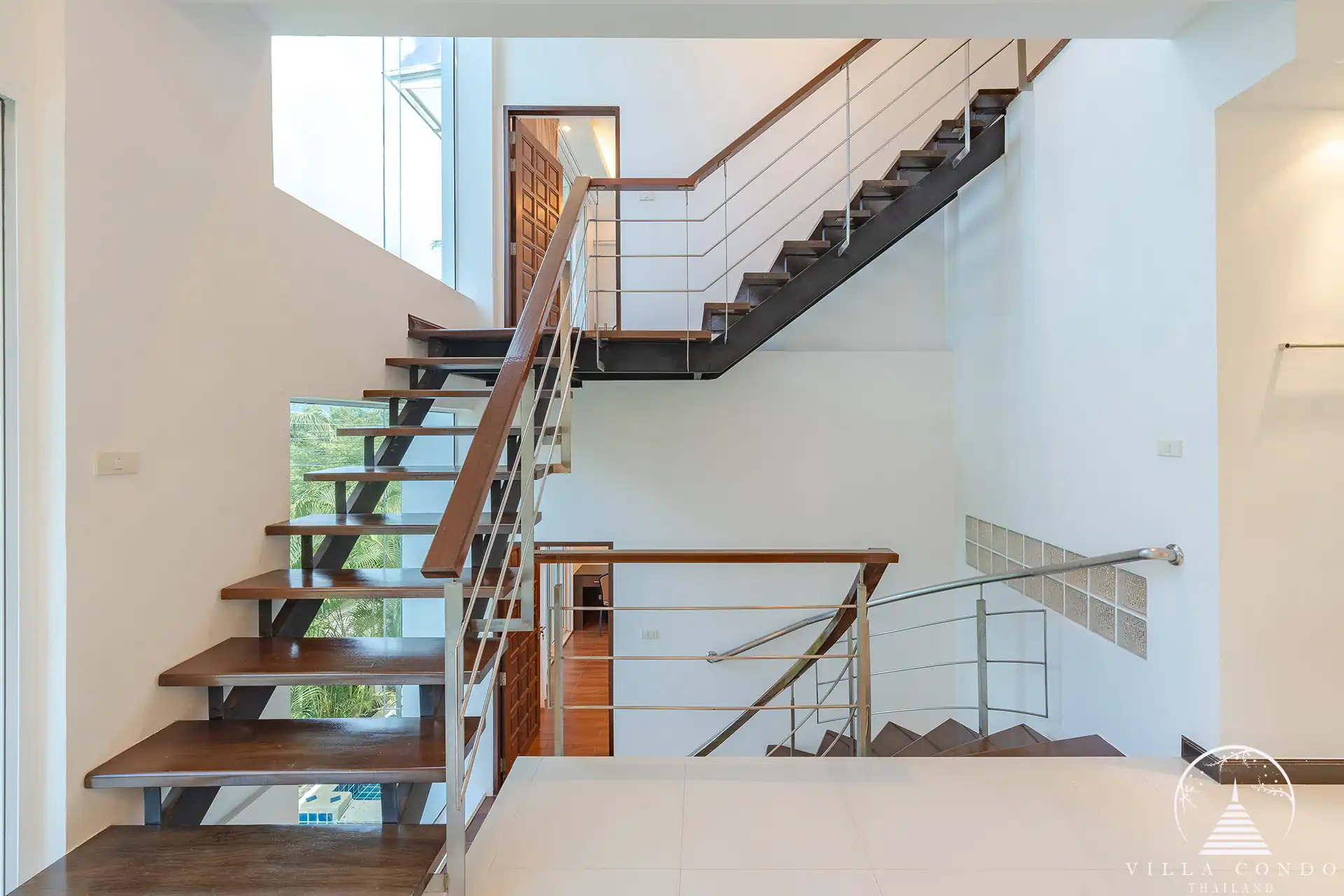 White Villa Patong modern staircase connecting all three levels of the villa.