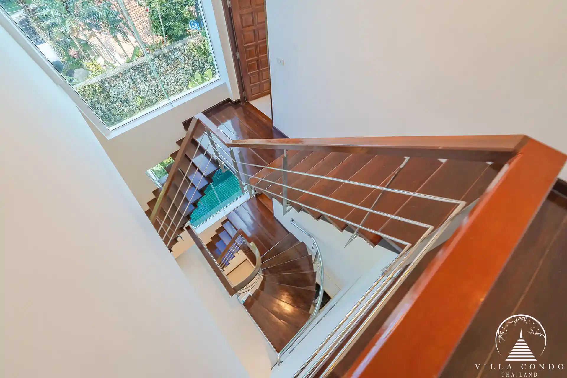 White Villa Patong modern staircase connecting all three levels of the villa.