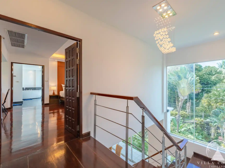 White Villa Patong modern staircase connecting all three levels of the villa.