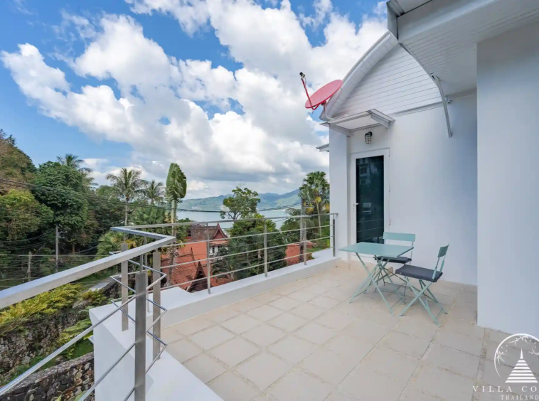 Balcony at White Villa Patong with views of the sea and mountains.