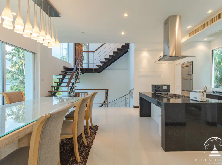 Dining area in White Villa Patong with modern décor and ocean views.