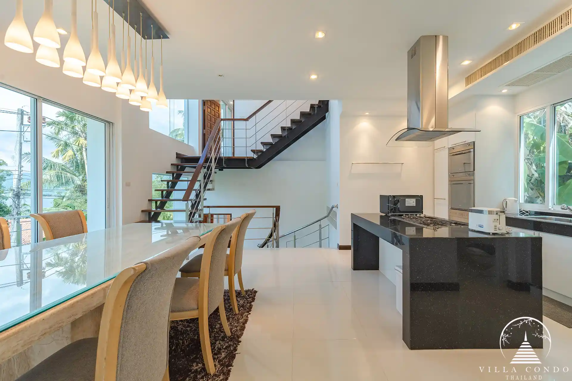 Dining area in White Villa Patong with modern décor and ocean views.