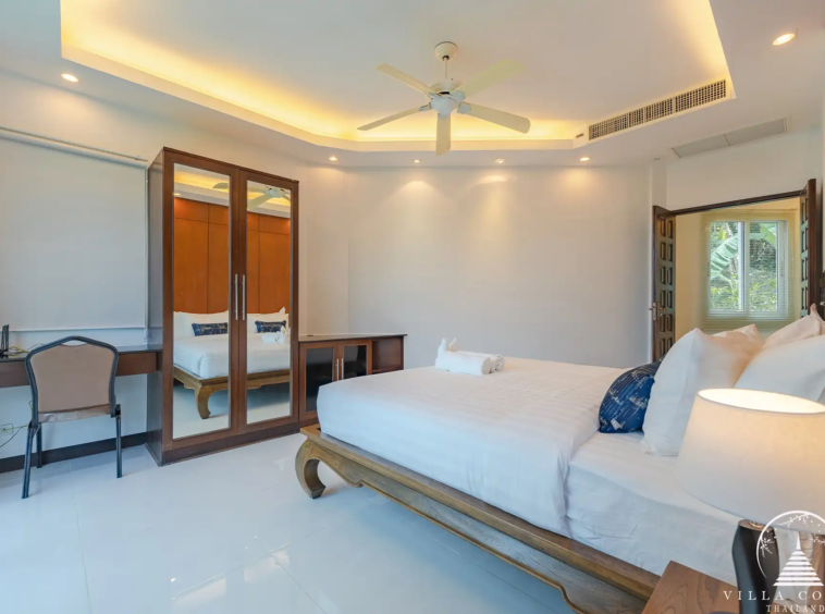 Guest bedroom in White Villa Patong with cozy décor and garden views.