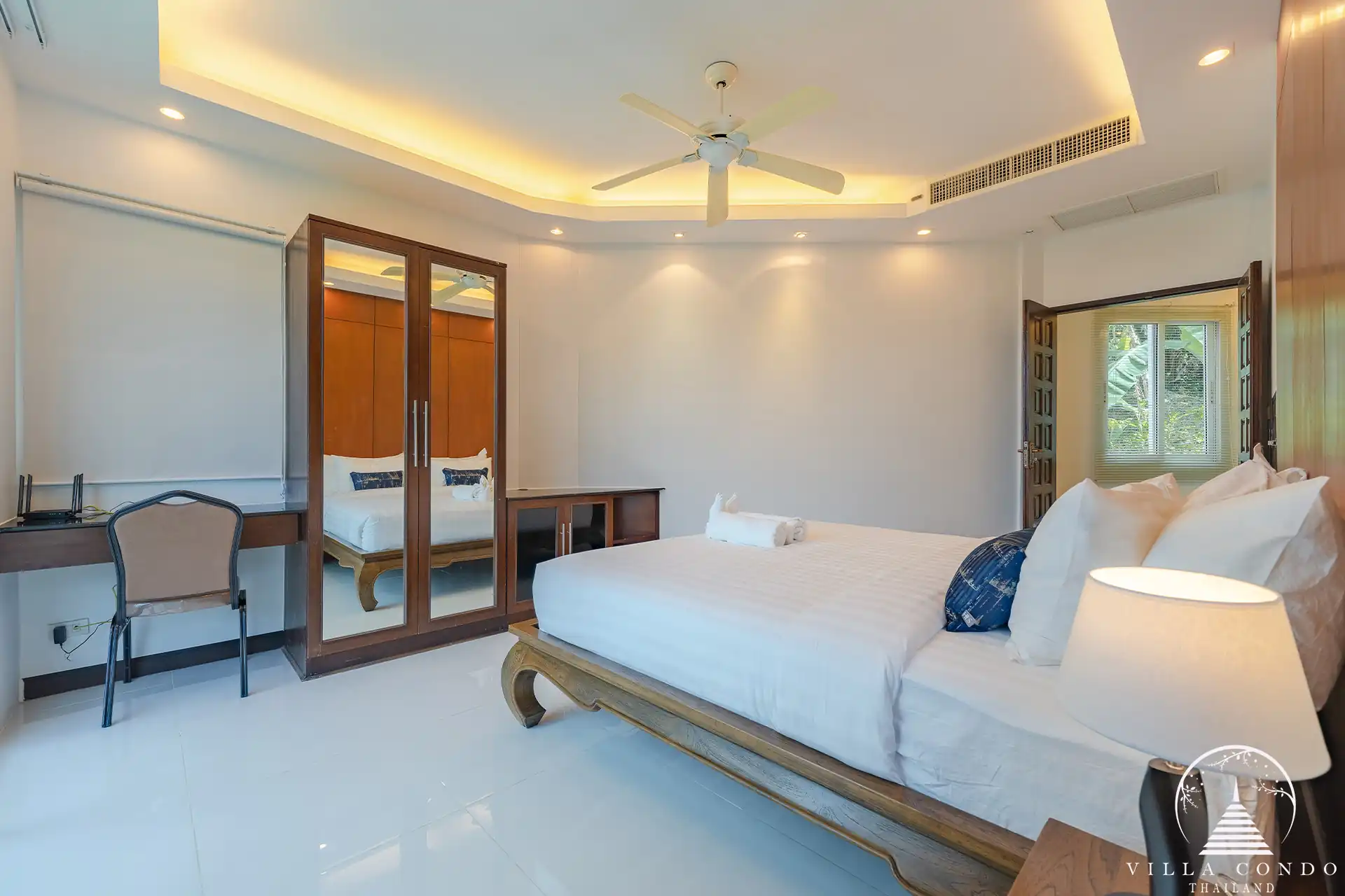 Guest bedroom in White Villa Patong with cozy décor and garden views.