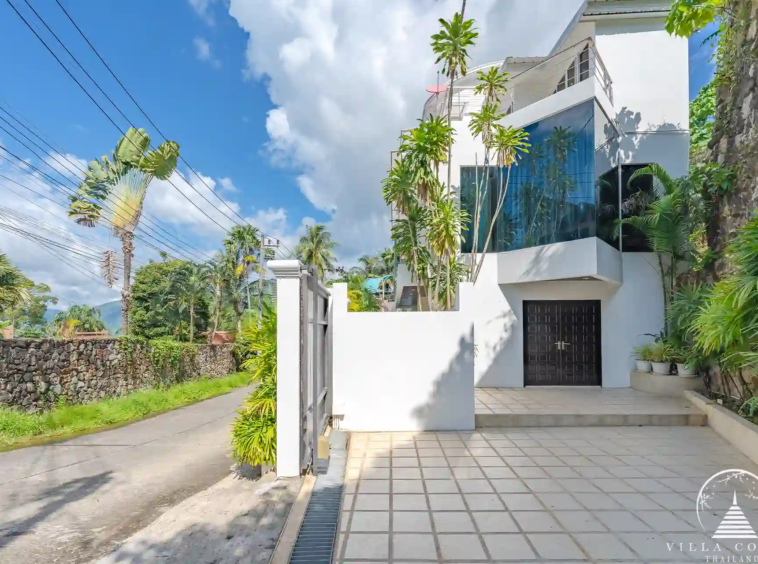 Main entrance of White Villa Patong with remote-controlled gates and private car park.