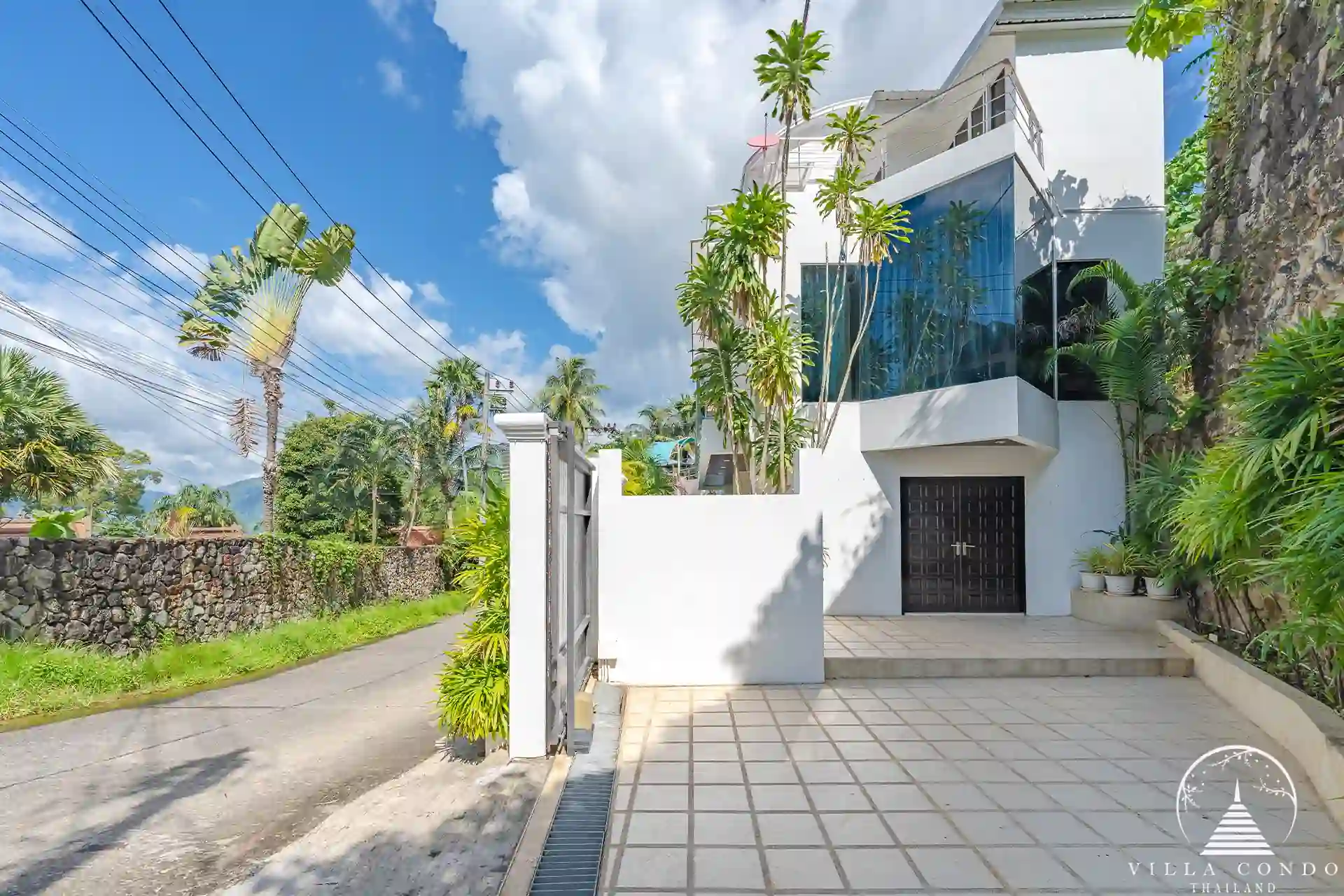 Main entrance of White Villa Patong with remote-controlled gates and private car park.