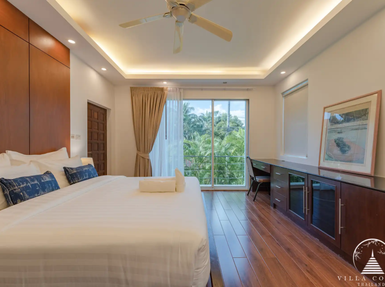 Second bedroom in White Villa Patong with modern décor and private balcony.