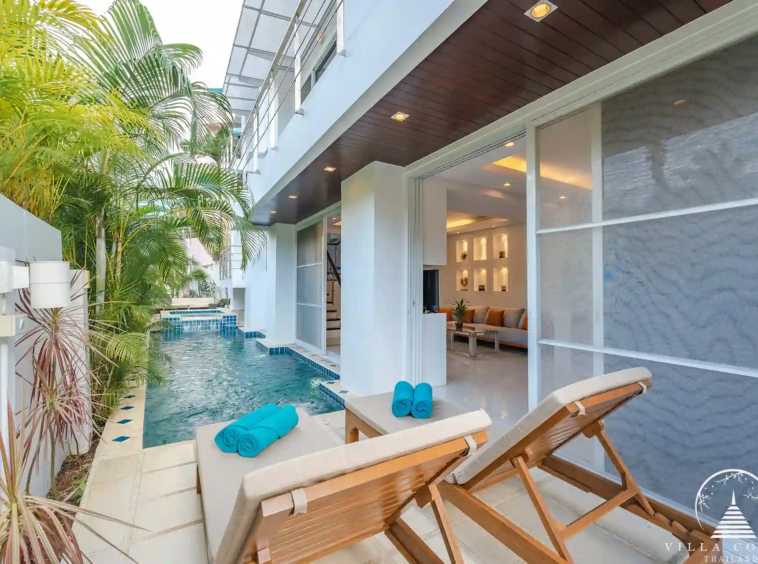 Outdoor area of White Villa Patong with pool and sea views.