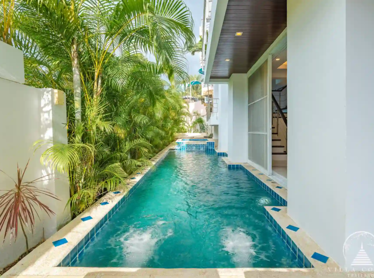 White Villa Patong landscaped garden with tropical plants.
