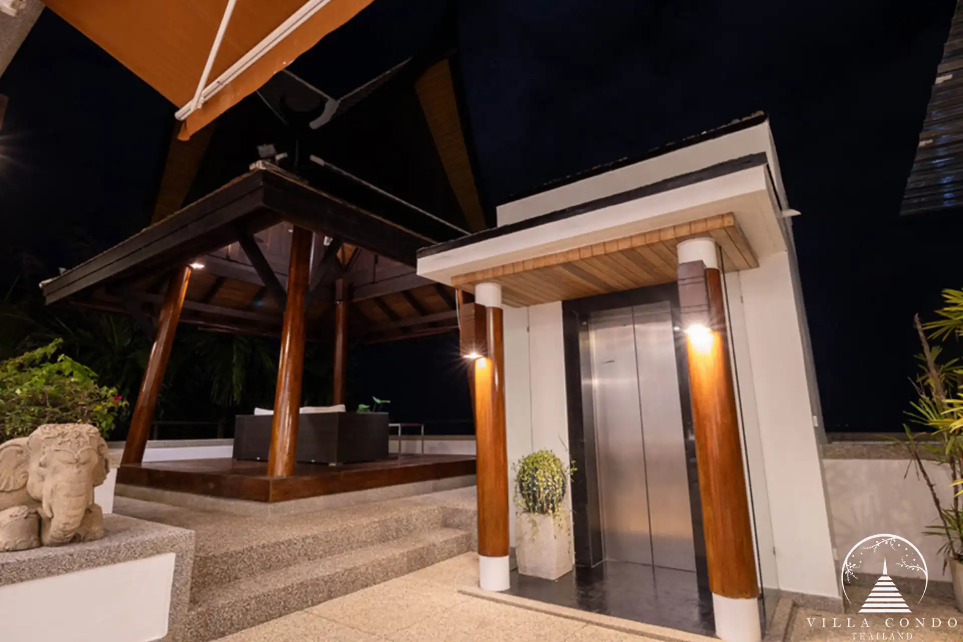 Grand entrance to Villa Yang Som with traditional Thai architecture and lush greenery