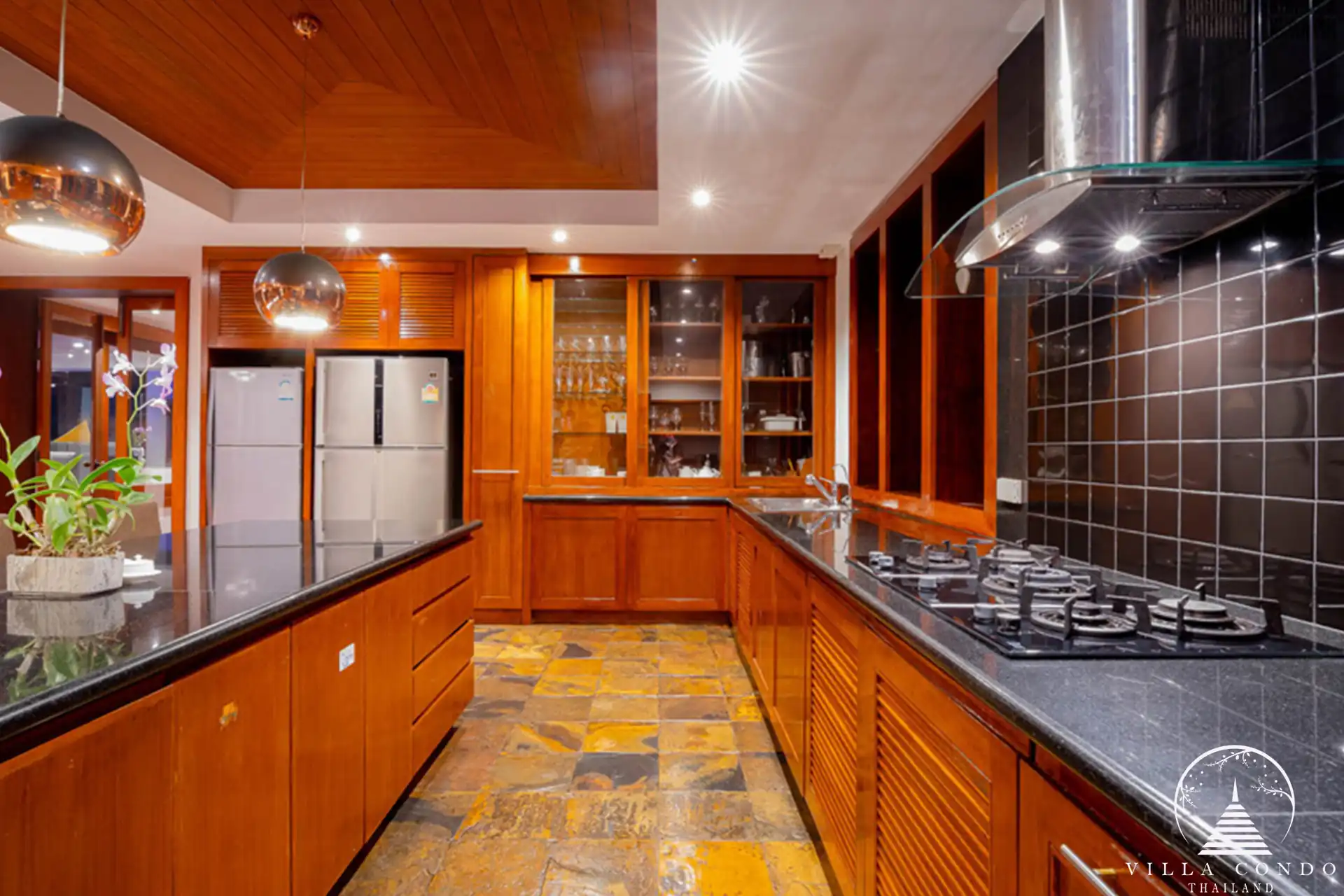 Traditional Thai kitchen at Villa Yang Som with modern appliances and wooden cabinetry