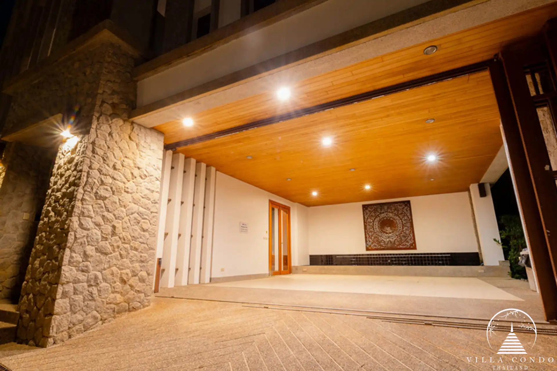 Grand entrance to Villa Yang Som with Thai-inspired architecture and tropical landscaping