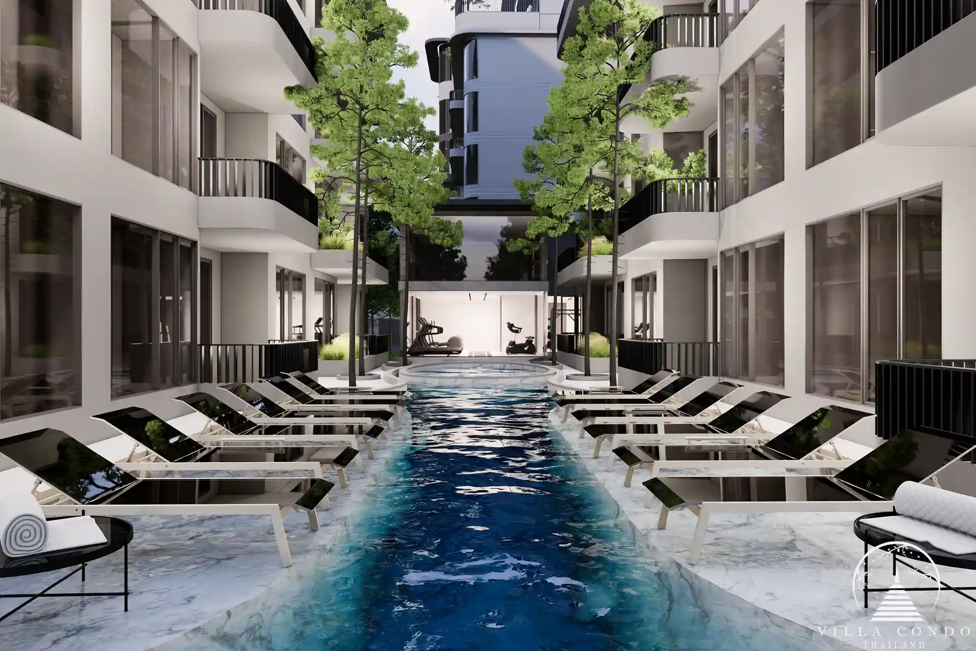 The Element Condo Kamala poolside area with loungers and modern design