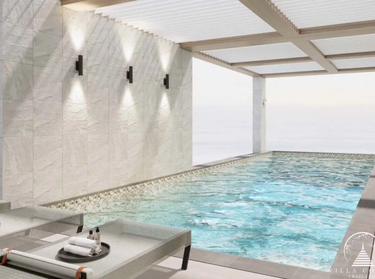 The Forest Patong Condo indoor lap pool with loungers and lights