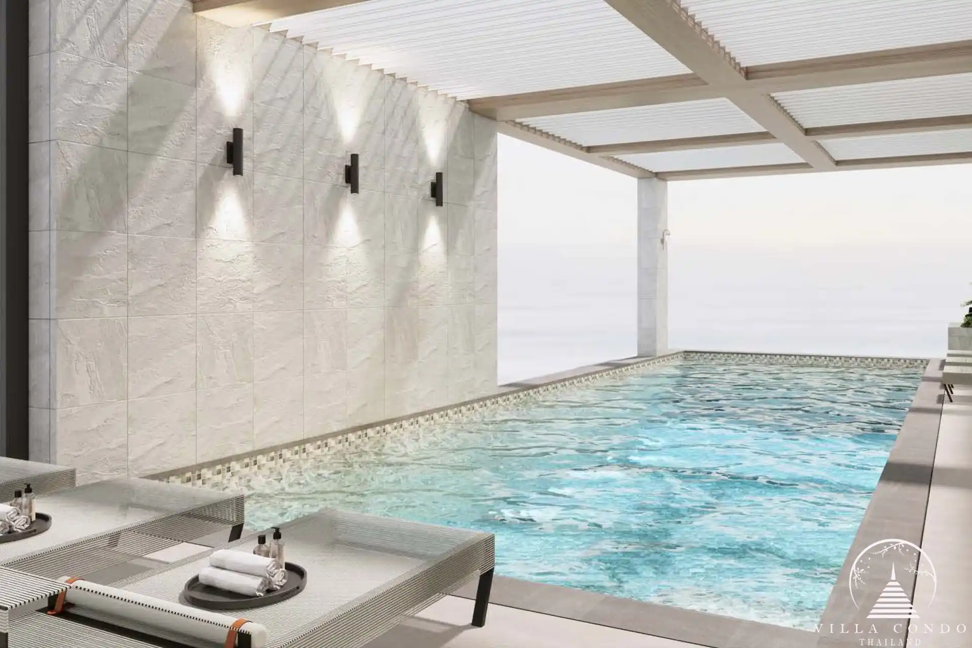 The Forest Patong Condo indoor lap pool with loungers and lights