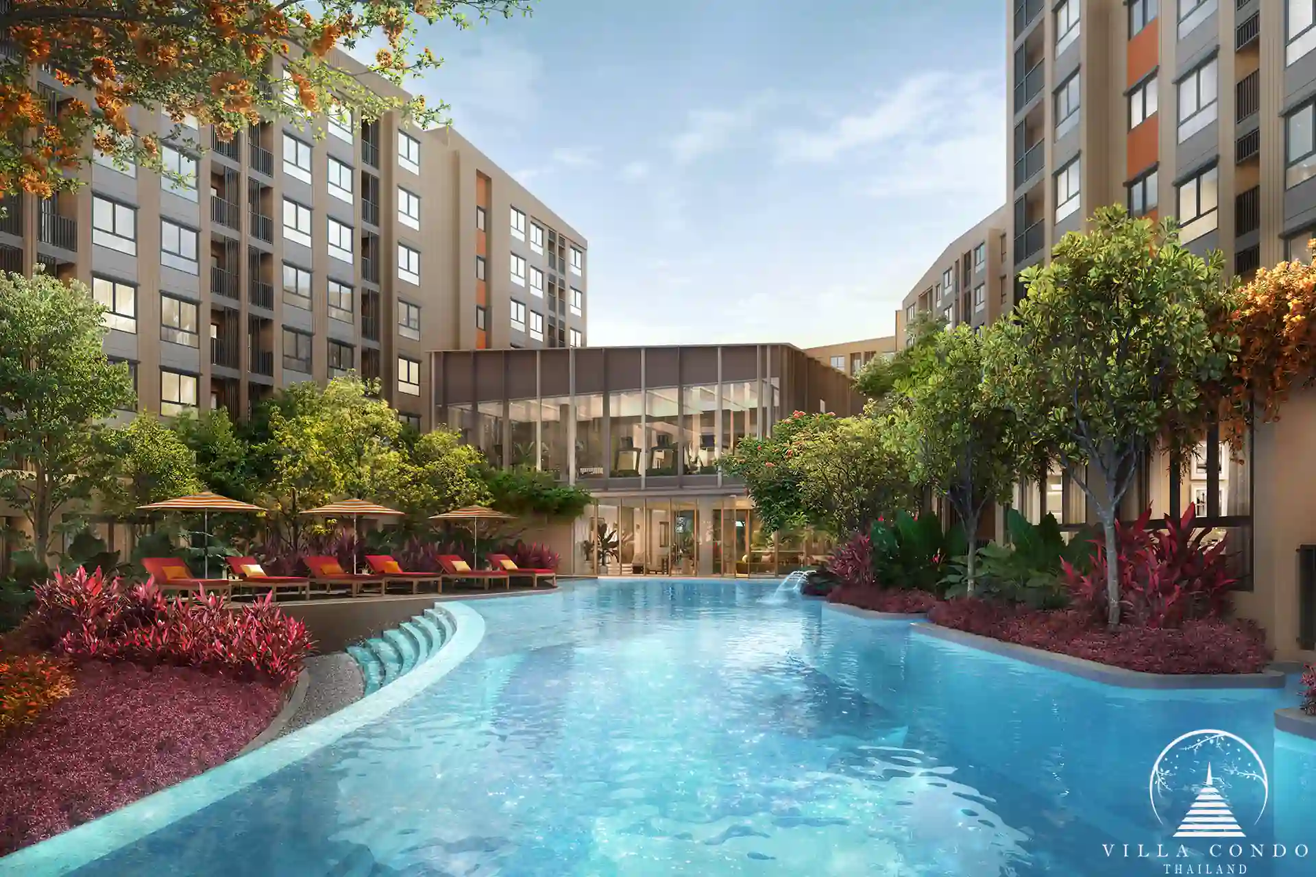 Dcondo Cove lagoon pool by glass clubhouse amid tropical gardens Phuket